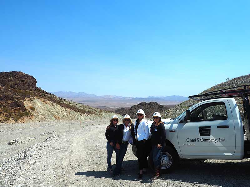 C and S staff beside a company truck on a desert jobsite
