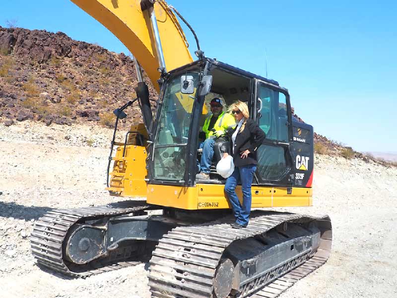 A C and S operator in the cab of a tracked excavator