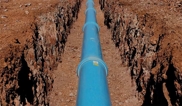 New pipe laid and bedded in an open utility trench